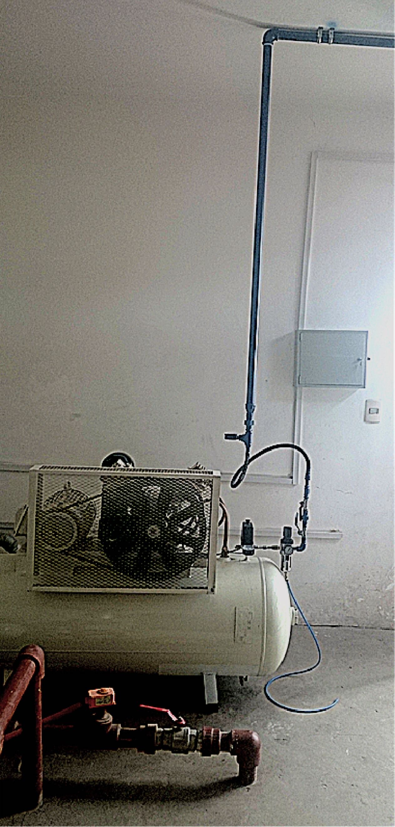Compresor con tanque horizontal blanco junto a una pared